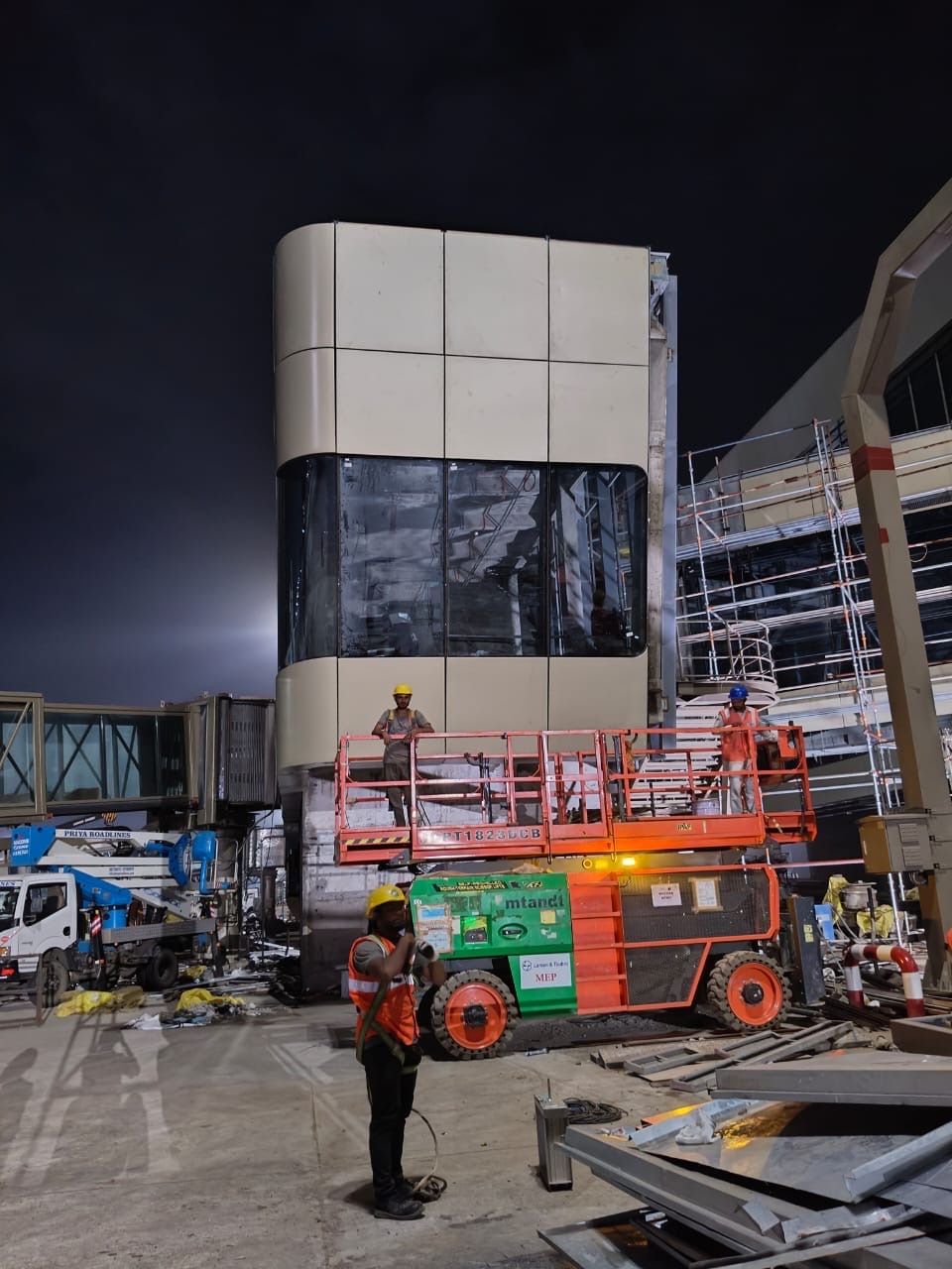 Facade installation with access equipment at night