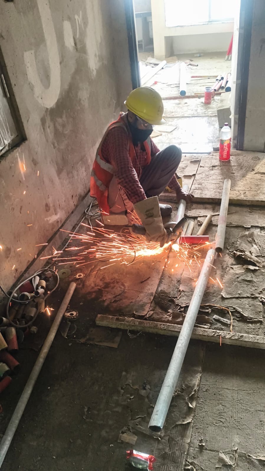 Worker cutting fire fighting pipework on site